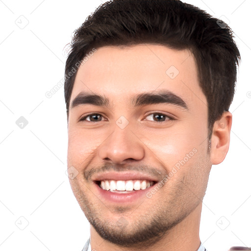 Joyful white young-adult male with short  black hair and brown eyes