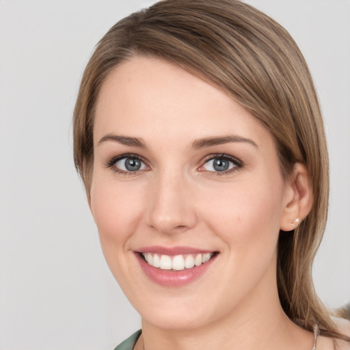 Joyful white young-adult female with medium  brown hair and green eyes