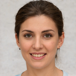 Joyful white young-adult female with medium  brown hair and green eyes