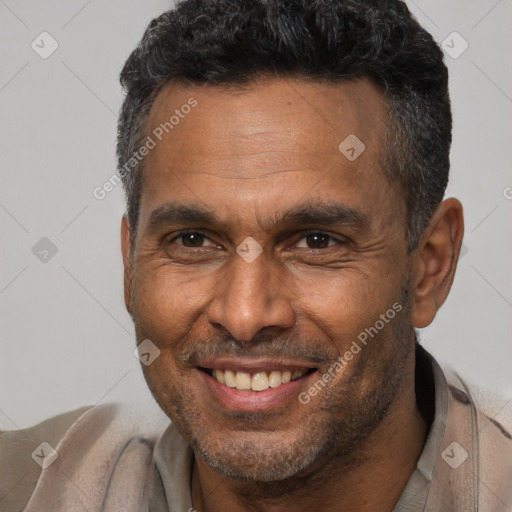 Joyful black adult male with short  brown hair and brown eyes