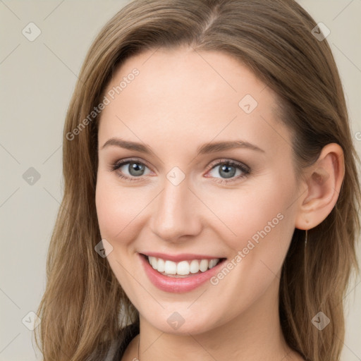 Joyful white young-adult female with long  brown hair and blue eyes