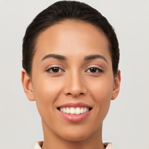 Joyful white young-adult female with short  brown hair and brown eyes