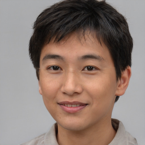 Joyful asian young-adult male with short  brown hair and brown eyes