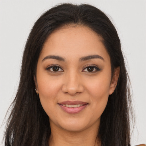 Joyful latino young-adult female with long  brown hair and brown eyes