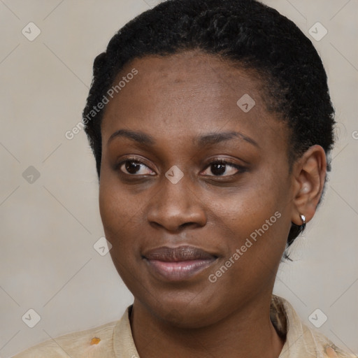 Joyful black young-adult female with short  black hair and brown eyes