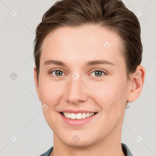 Joyful white young-adult female with short  brown hair and grey eyes