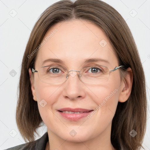 Joyful white adult female with medium  brown hair and grey eyes