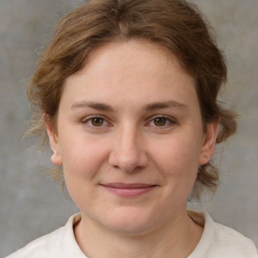 Joyful white young-adult female with medium  brown hair and grey eyes