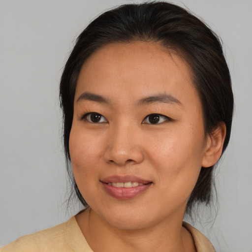 Joyful asian young-adult female with medium  brown hair and brown eyes