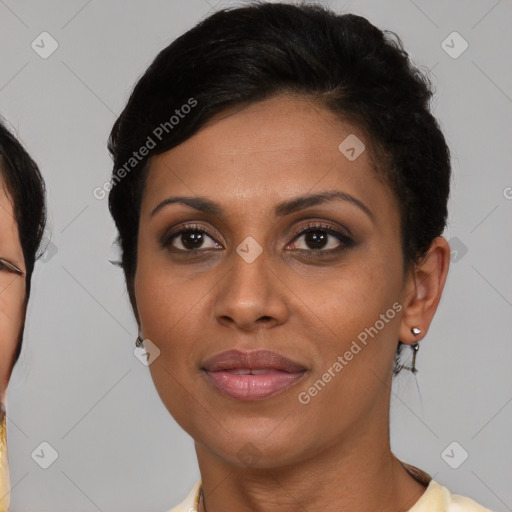 Joyful latino adult female with short  brown hair and brown eyes