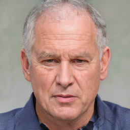 Neutral white middle-aged male with short  gray hair and brown eyes