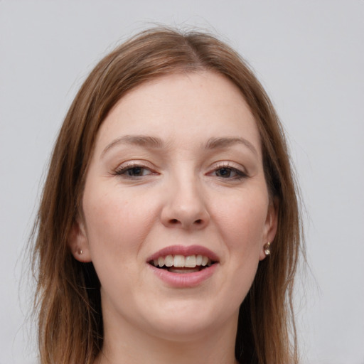 Joyful white young-adult female with long  brown hair and grey eyes