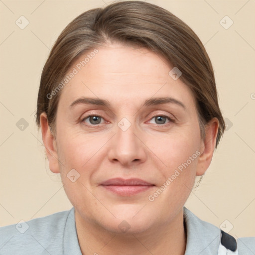 Joyful white adult female with short  brown hair and grey eyes