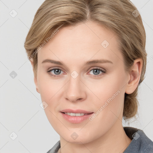 Joyful white young-adult female with medium  brown hair and blue eyes