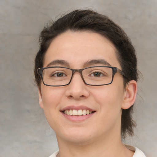 Joyful white young-adult female with medium  brown hair and brown eyes