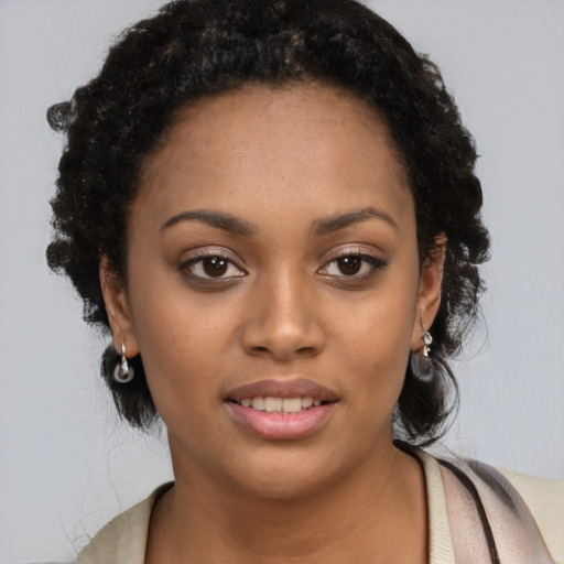 Joyful black young-adult female with short  black hair and brown eyes