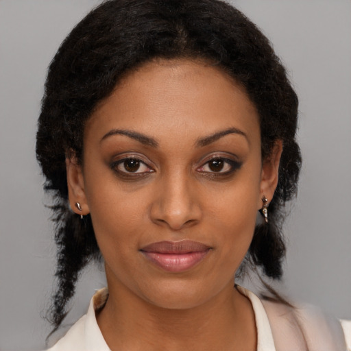 Joyful black young-adult female with medium  brown hair and brown eyes