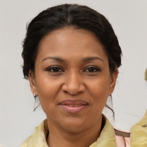 Joyful black adult female with medium  brown hair and brown eyes
