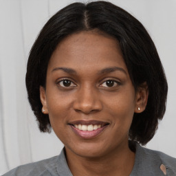 Joyful black young-adult female with medium  brown hair and brown eyes