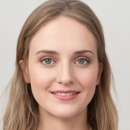 Joyful white young-adult female with long  brown hair and grey eyes