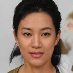 Joyful asian young-adult female with medium  black hair and brown eyes