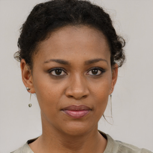 Joyful black young-adult female with short  brown hair and brown eyes