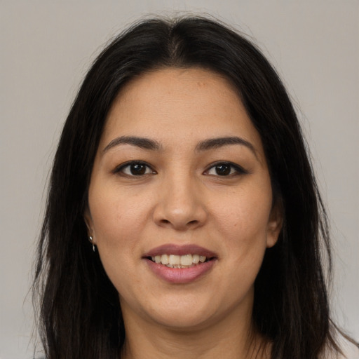 Joyful latino young-adult female with long  brown hair and brown eyes