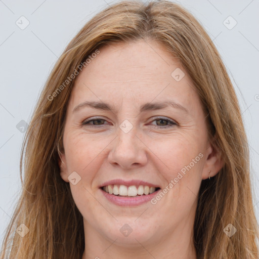 Joyful white adult female with long  brown hair and brown eyes