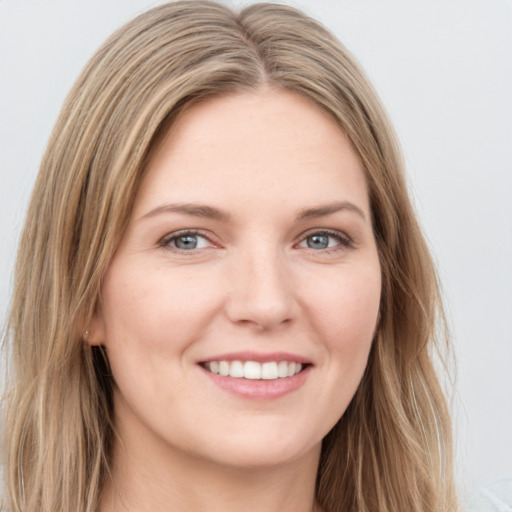 Joyful white young-adult female with long  brown hair and green eyes