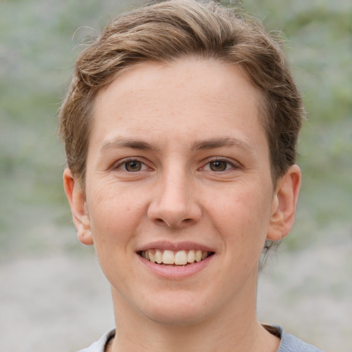 Joyful white young-adult female with short  brown hair and grey eyes