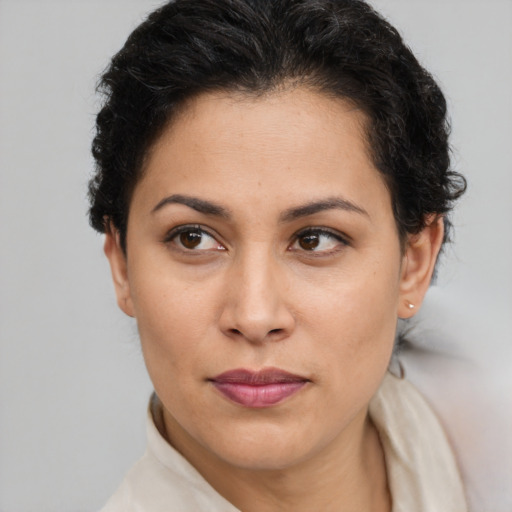 Joyful latino young-adult female with short  brown hair and brown eyes