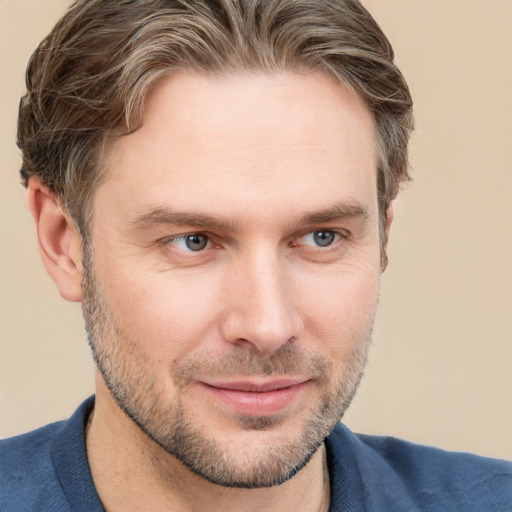 Joyful white adult male with short  brown hair and grey eyes