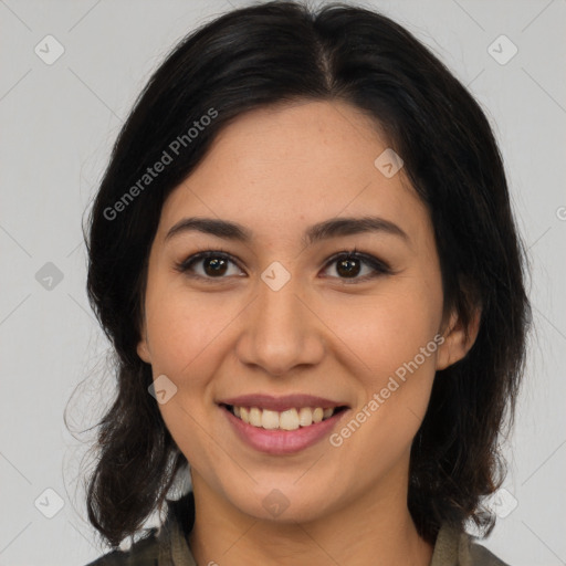 Joyful latino young-adult female with medium  brown hair and brown eyes