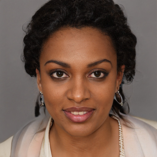 Joyful black young-adult female with long  brown hair and brown eyes