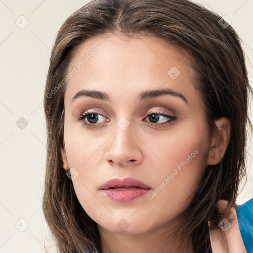 Neutral white young-adult female with long  brown hair and brown eyes