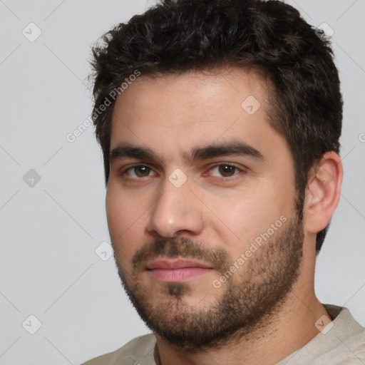 Joyful white young-adult male with short  black hair and brown eyes