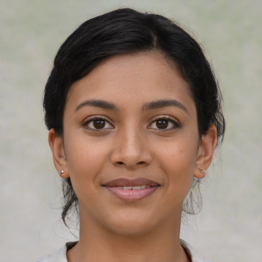 Joyful latino young-adult female with medium  black hair and brown eyes