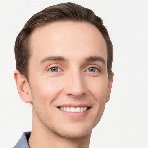 Joyful white young-adult male with short  brown hair and grey eyes