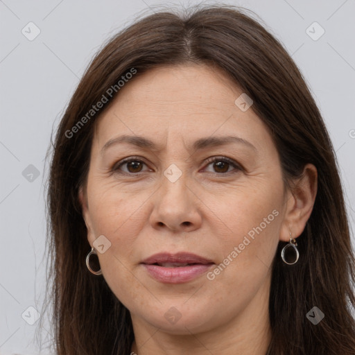 Joyful white adult female with long  brown hair and brown eyes