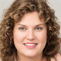 Joyful white young-adult female with long  brown hair and green eyes