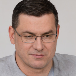 Joyful white adult male with short  brown hair and brown eyes