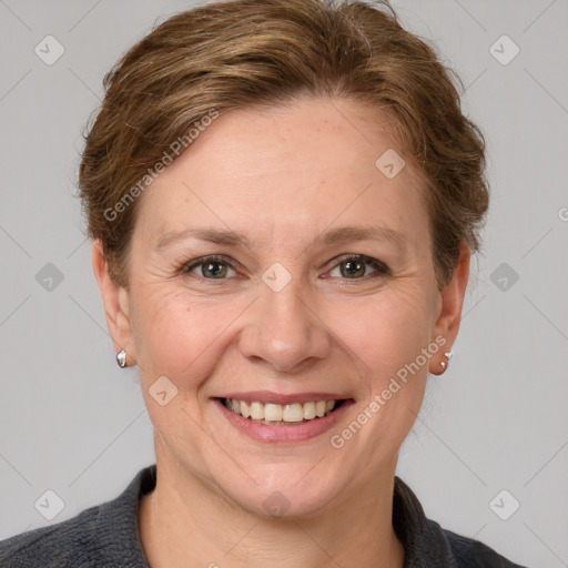 Joyful white adult female with short  brown hair and grey eyes