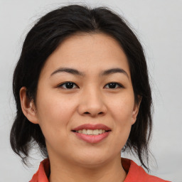 Joyful asian young-adult female with medium  brown hair and brown eyes