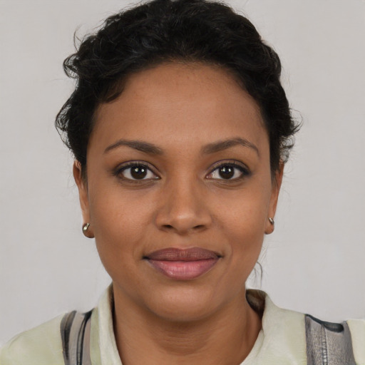Joyful latino young-adult female with medium  brown hair and brown eyes