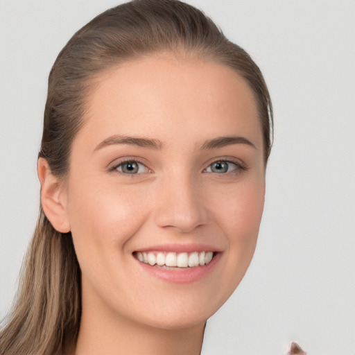 Joyful white young-adult female with long  brown hair and grey eyes