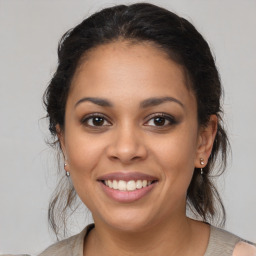 Joyful latino young-adult female with medium  brown hair and brown eyes