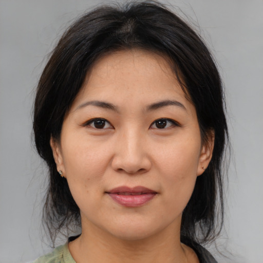 Joyful asian young-adult female with medium  brown hair and brown eyes