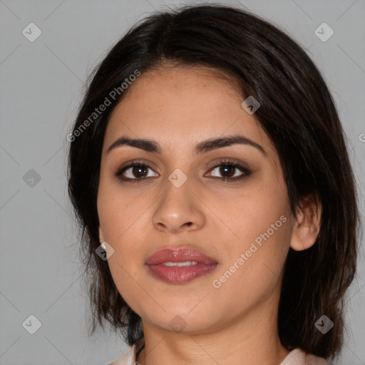 Joyful latino young-adult female with medium  brown hair and brown eyes