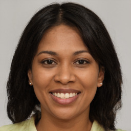 Joyful black young-adult female with medium  brown hair and brown eyes