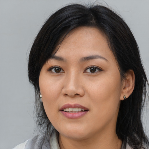 Joyful asian young-adult female with medium  black hair and brown eyes